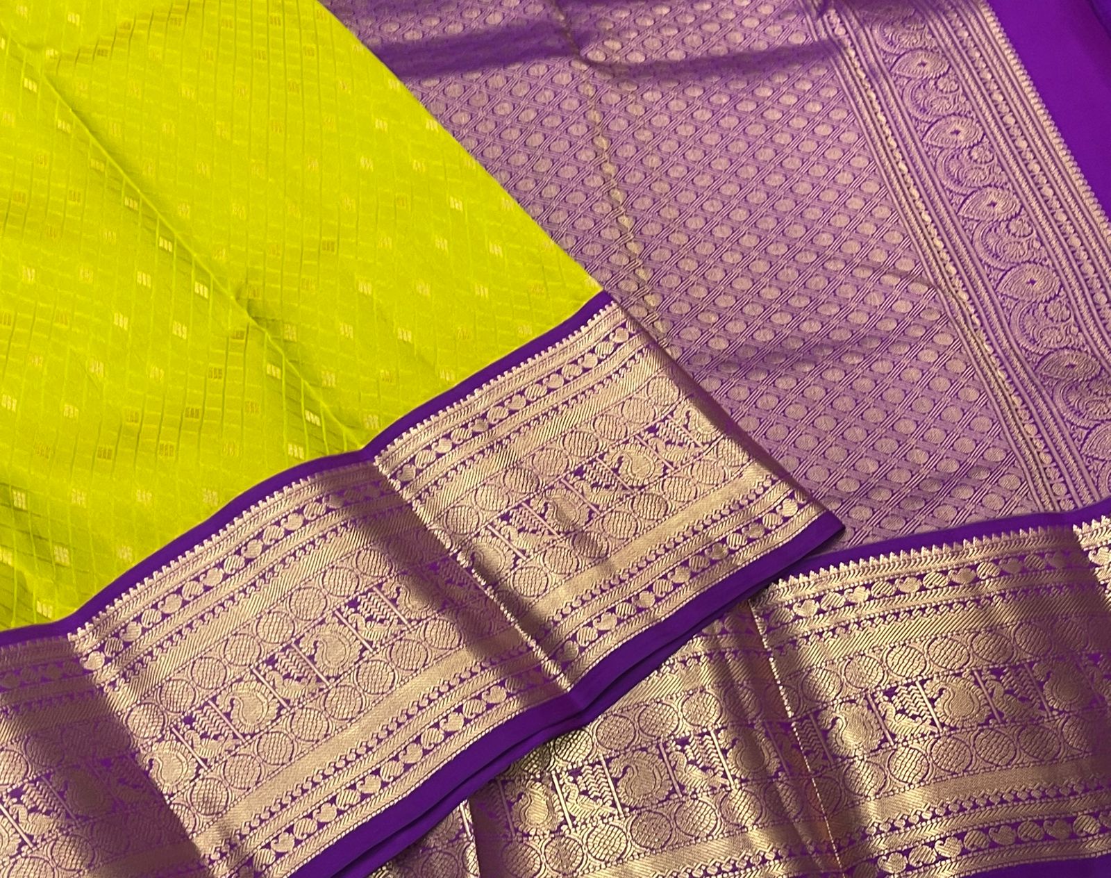 Rani Pink Kanjivaram Silk Saree with a Contrast Purple Zari Border.